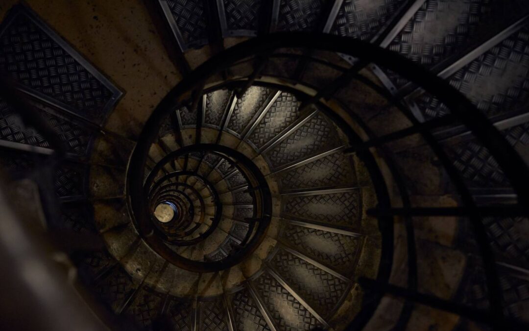 Intricate spiral staircase in Paris offering a mesmerizing architectural view from above.